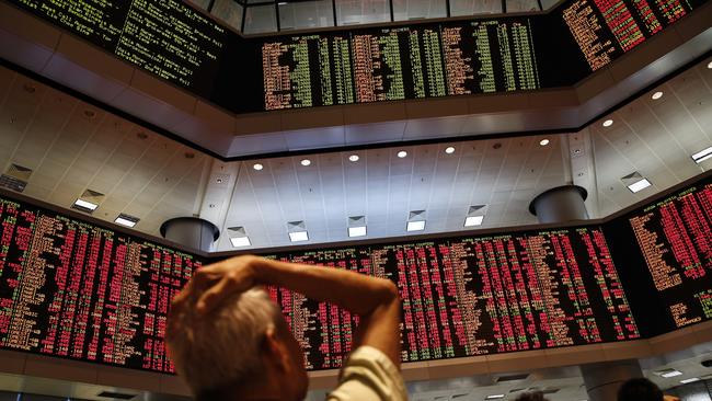 Market turmoil ... People watch trading boards at a private stock market gallery. Picture: AP