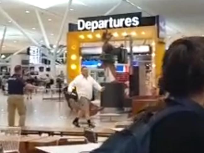 Special officers shadow a man with a knife at Brisbane Airport’s international terminal last night.