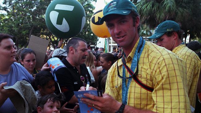 Rower Jaime Fernandez signs autographs during a ticker-tape parade in Darwin in 2000. Photo: Clive Hyde.