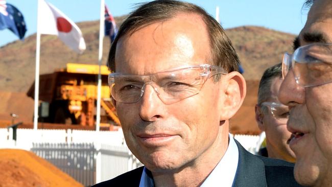 Prime Minister Tony Abbott, left, and Japanese Prime Minister Shinzo Abe tour the Rio Tinto West Angelas iron ore mine in the Pilbara, Western Australia, Wednesday, July 9, 2014. Abe is in Australia on a four day official visit (AP Photo/Alan Porritt, Pool)