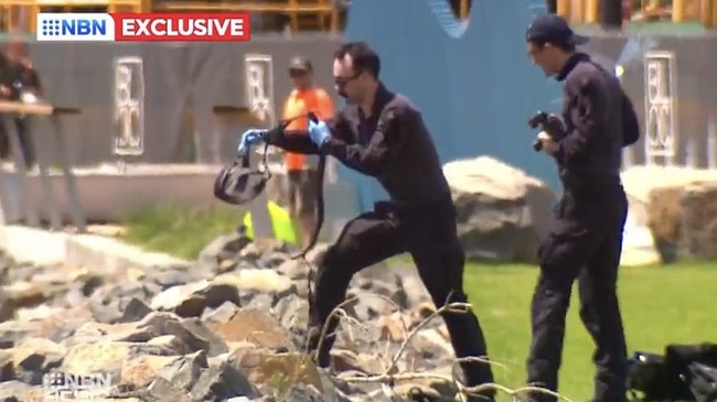 Federal police investigating cocaine haul inspect at what appears to be diving equipment discovered on the shore of Newcastle Harbour near Honeysuckle Drive on January 25, 2023. Picture: NBN News