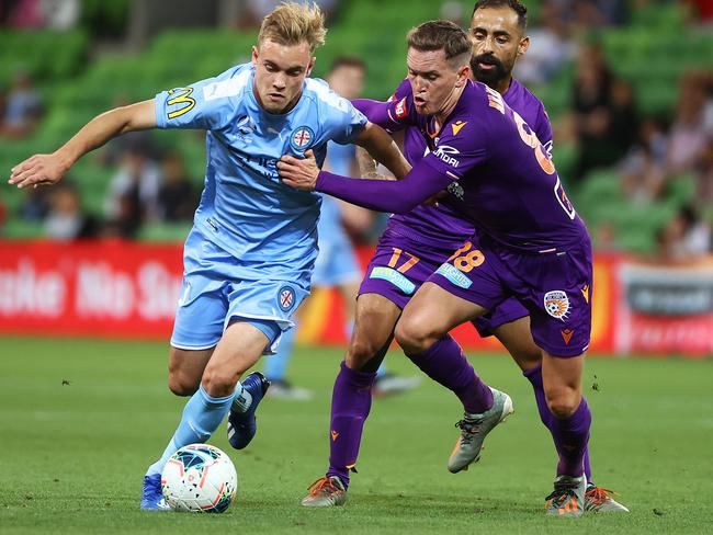 Nathaniel Atkinson and Glory’s Neil Kilkenny contest the ball.