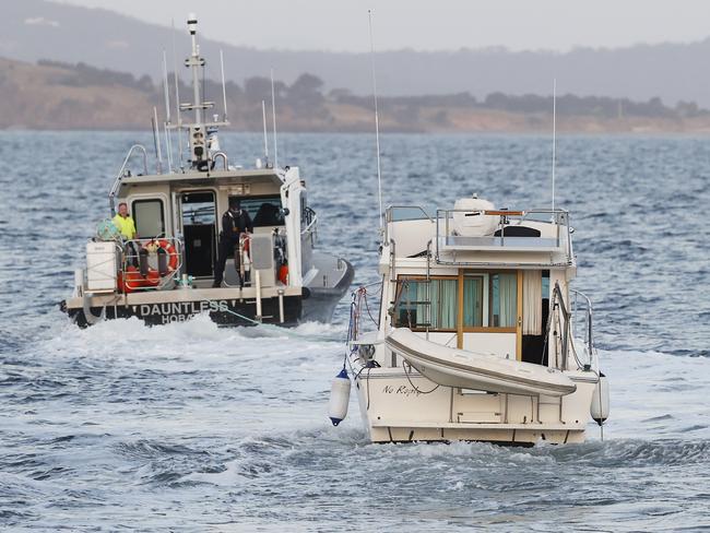 Tasmania Police vessel Dauntless towing the boat No Replay.  Boat washed up on Kingston Beach with no one on board.  Picture: Nikki Davis-Jones