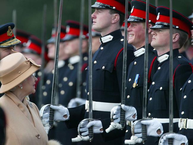 Prince Harry, second from right, grins and his grandmother Queen Elizabeth II smiles, as she inspects the Sovereign's Parade at the Royal Military Academy in Sandhurst, England, in 2006. Picture: AP