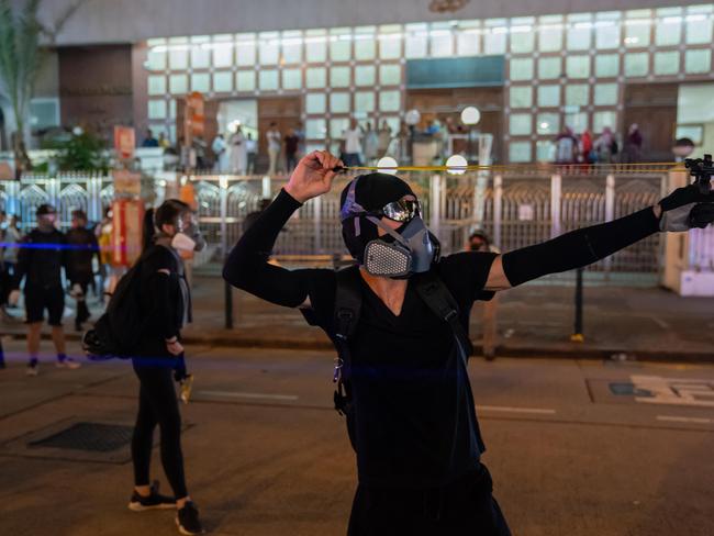 Protesters use a slingshot during clashes with police at a demonstration in the Tsim Sha Tsui area. Picture: Getty