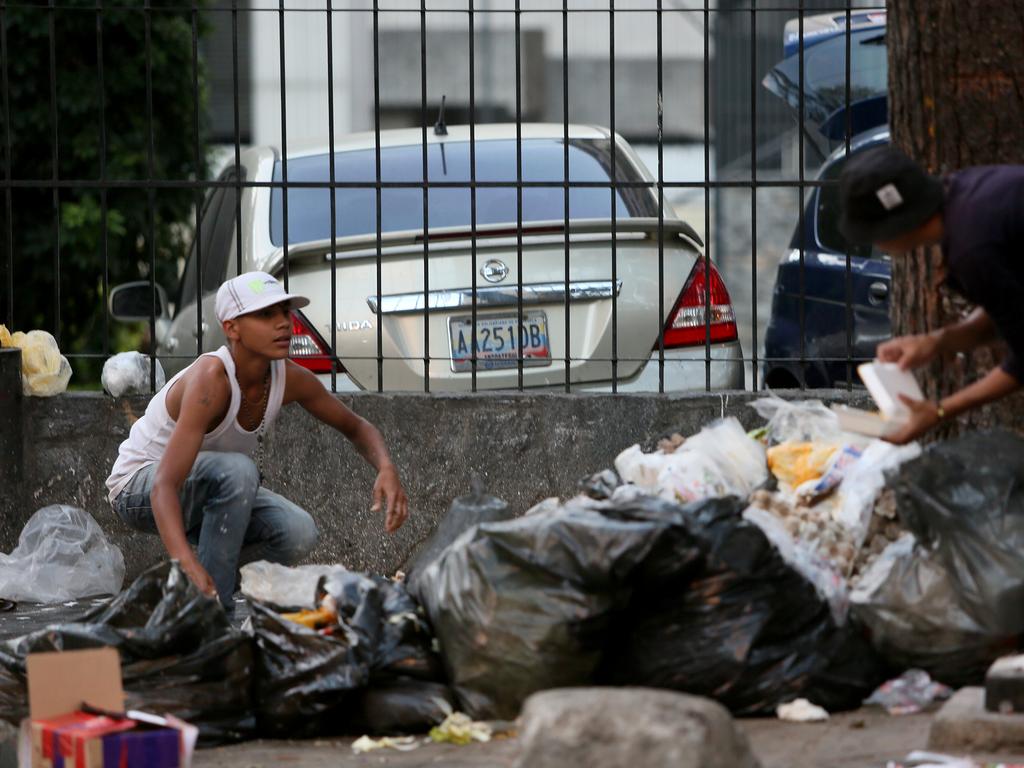 People look for food in the garbage due the extreme food shortages at Sabana Grande on January 31, 2019 in Caracas, Venezuela. Picture: Edilzon Gamez/Getty Images