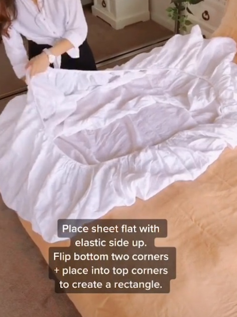 Mila begins with placing the sheet flat on the bed with the elastic side up. Picture: TikTok/mama_mila_