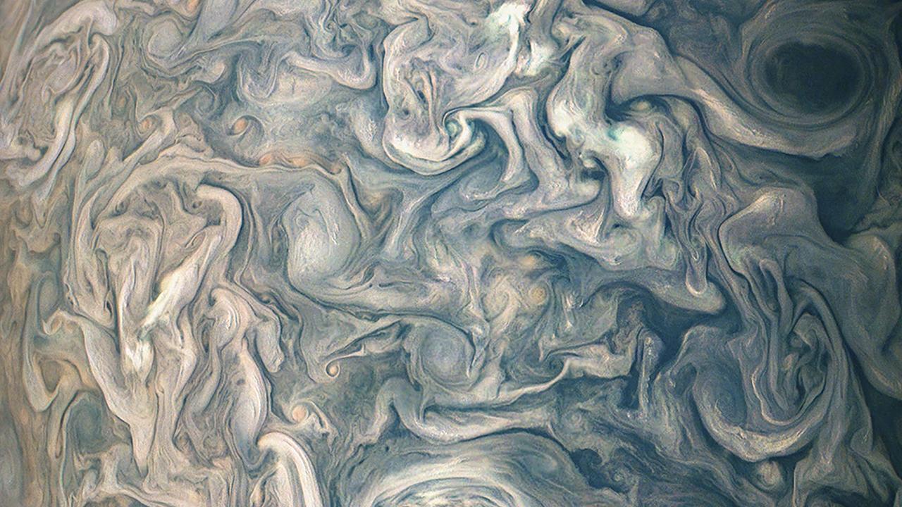 Swirling clouds surround Jupiter.