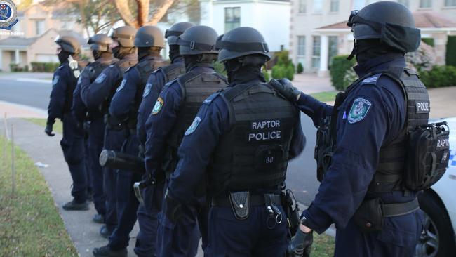 Officers in Strike Force Raptor prepare for a raid in Sydney’s south west. Picture: NSW Police