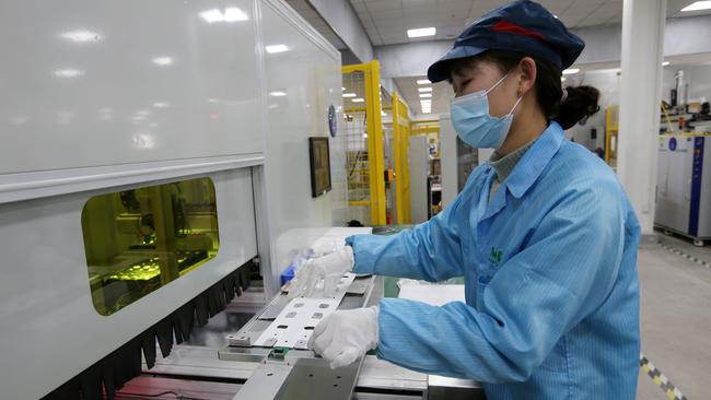 An employee working on a battery production line in the workshop of a new energy company in Huaibei. Picture: AFP