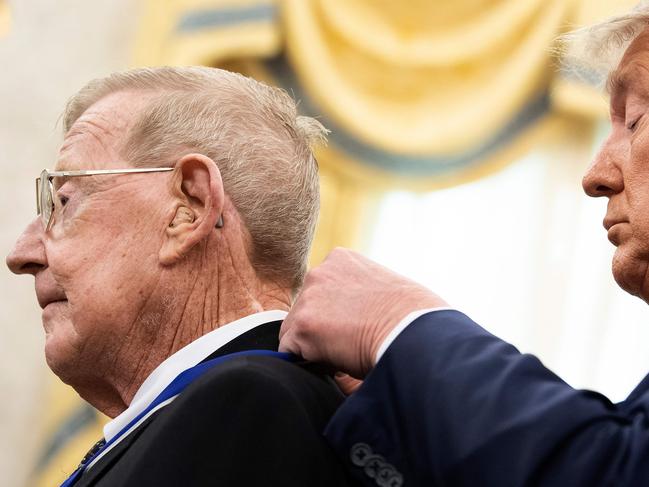 US President Donald Trump awards the Presidential Medal of Freedom to retired football coach Lou Holtz. Picture: AFP