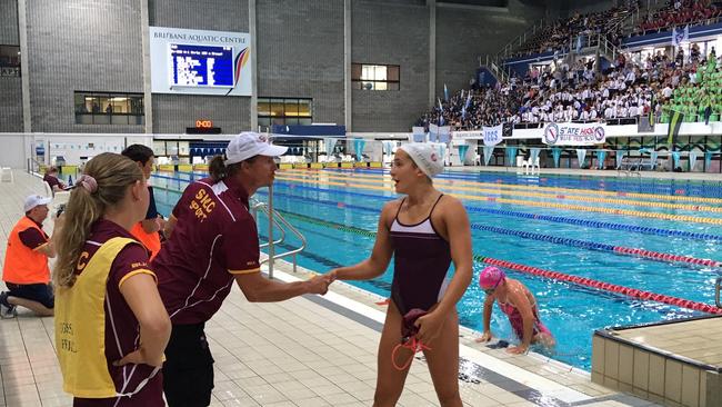 Jenna Forrester is congratulated by her coach Dean Boxall from St Peters at the 2020 QGSSSA swimming carnival.