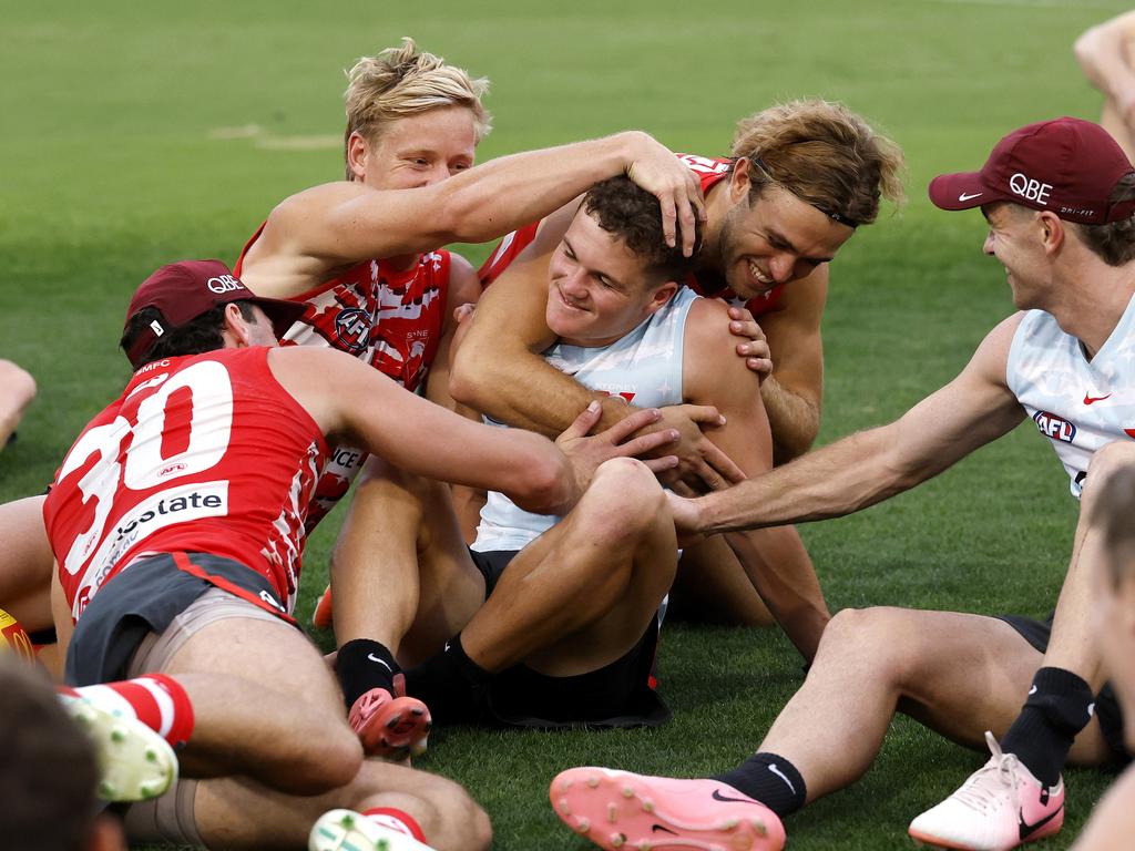 Tom Hanily is embraced by teammates after learning of his AFL debut. Picture: Phil Hillyard