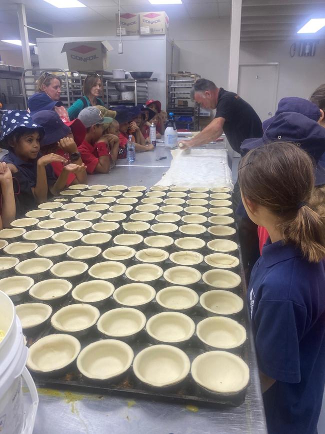 Darren Clark showing schoolchildren the ropes at the NT Bakery during a school tour.