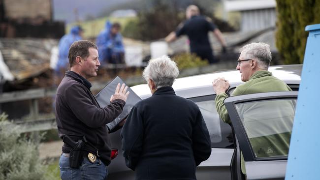 Police speak to neighbours at the scene of a house fire at Fourfoot Rd, Geeveston. Picture Chris Kidd