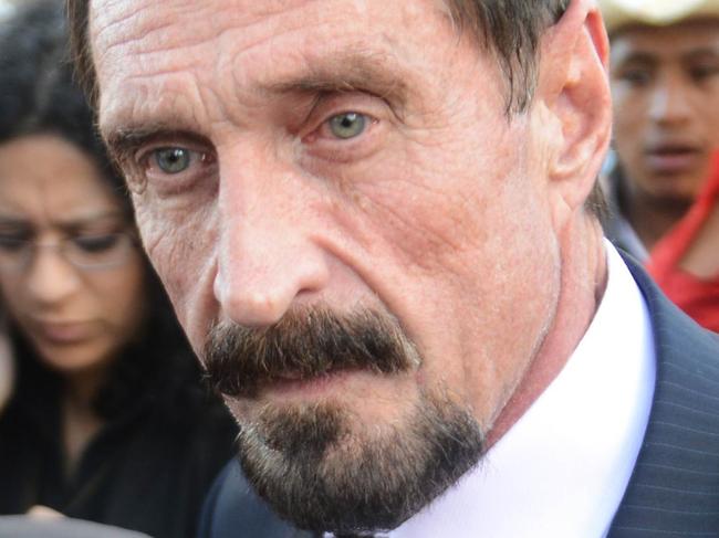 US anti-virus software pioneer John McAfee (R) answers questions to journalistas next to his Guatemalan lawyer Telesforo Guerra (L), in front of the Supreme Court in Guatemala City on December 04, 2012. McAfee, wanted for questioning over the murder of his neighbor last month in Belize, is seeking political asylum in Guatemala. AFP PHOTO / Johan ORDONEZ