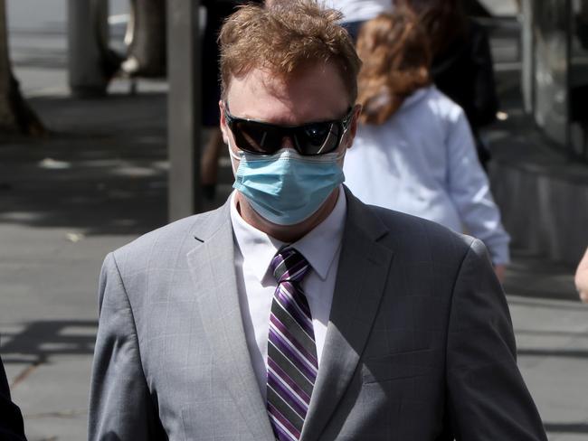 SYDNEY, AUSTRALIA - NewsWire Photos MARCH 11, 2022: Harry Little pictured (right) as he arrives at Downing Centre Courts, Sydney CBD. A Highway Patrol officer, who was charged following a crash which left Cronulla woman Gai Vieira with severe brain injury, has been found not guilty of dangerous driving occasioning grievous bodily harm. He pleaded guilty to neg driving instead. Picture: NCA NewsWire / Damian Shaw