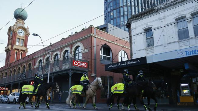 Police patrol a deserted Swan St in Richmond on Grand Final day. Picture: Daniel Pockett/Getty Images