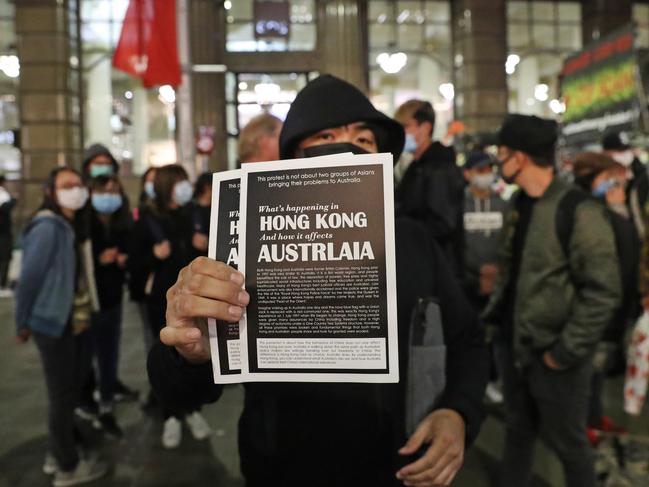 Masked protesters pictured at Martin Place in Sydney. Picture: Richard Dobson