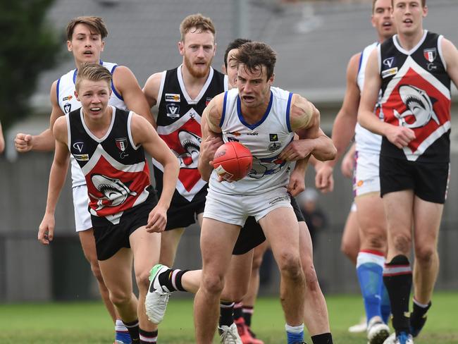 Mornington’s Joel Miller tries to break a tackle. Picture: Chris Eastman