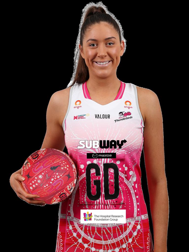 Thunderbirds player Matilda Garrett shows off her club’s dress and the official indigenous round ball.