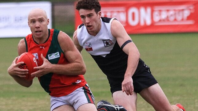 Josh Adams (The Basin) looks to give Jayden Cairns (Ringwood) the slip in the Eastern Football League (EFL). Picture: Davis Harrigan