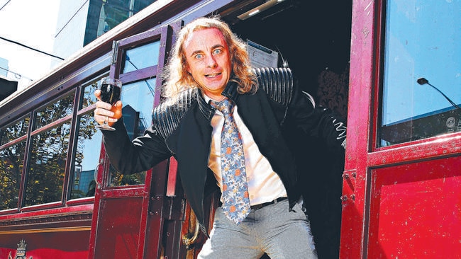 Paul Foot hanging out (literally) at the Colonial Tramcar restaurant, one of his favourite spots for a feed during the Melbourne International Comedy Festival. Picture ANDREW TAUBER