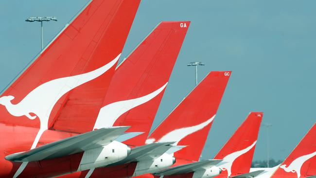 **FILE** A Dec. 3, 2008 file photo of the tails of Qantas jets at Sydney International Airport. Qantas Airways Ltd's first-half profit slumped 66 per cent, Wednesday, Feb. 4, 2009, as fuel and labour costs buffeted Australia's biggest airline. (AAP Image/Dean Lewins,File) NO ARCHIVING