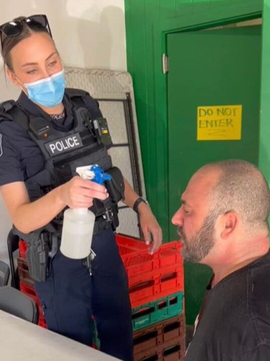 St Bernards Fruit &amp; Veg Market owner John Kapiris receiving assistance after the spray. Picture: Facebook