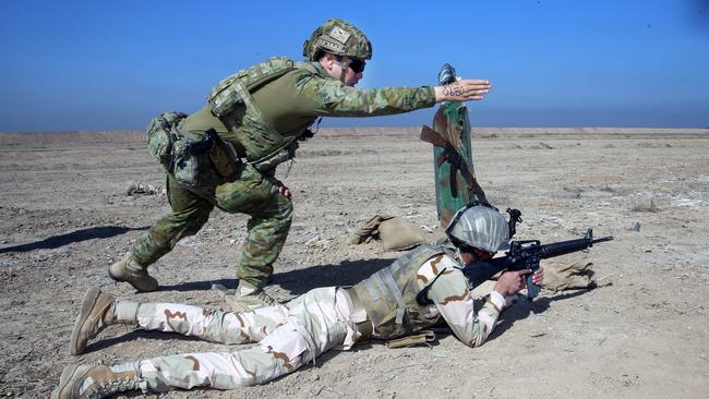 Corporal Bernard Edwards instructs Iraqi Security Force soldiers during a live fire and movement activity at a remote military base in north west Iraq. Picture Gary Ramage