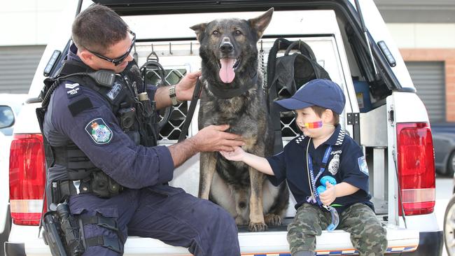 Slater makes friends with dog handler Nick Donald and Hondo. Picture Glenn Hampson