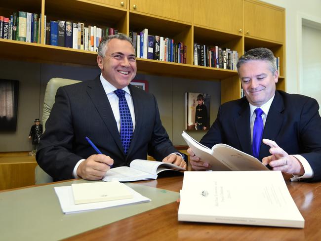 Treasurer Joe Hockey and Finance minister Mathias Corrman are seen during a picture opportunity preparing to deliver MYEFO at Parliament House in Canberra, Monday, Dec. 15, 2014. Treasurer Joe Hockey will hand down the Mid-Year Economic and Fiscal Outlook today. (AAP Image/Lukas Coch) NO ARCHIVING