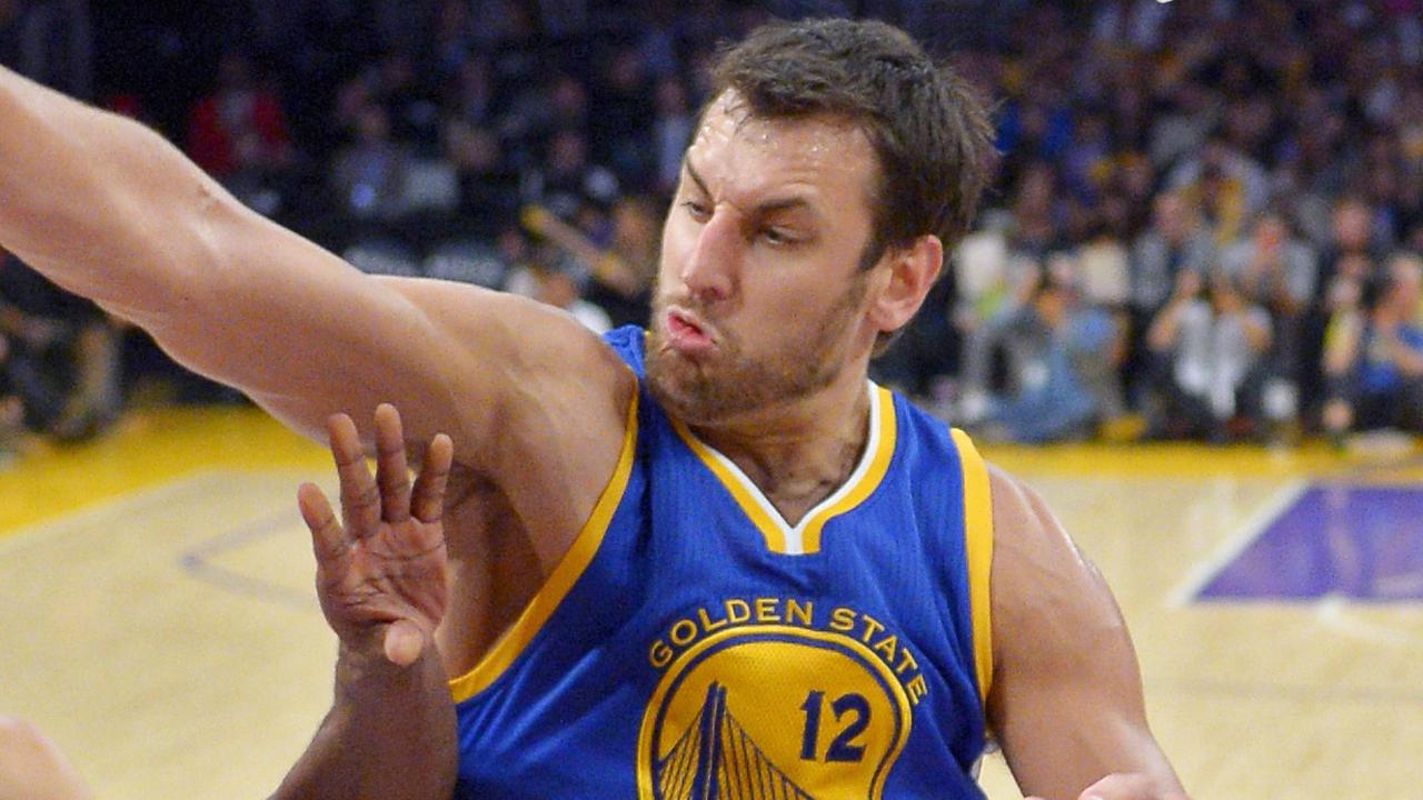 Los Angeles Lakers guard Kobe Bryant, center, puts up a shot as Golden State Warriors forward Draymond Green, left, and center Andrew Bogut, of Australia, defend during the second half of an NBA basketball game, Sunday, Nov. 16, 2014, in Los Angeles. The Warriors won 136-115. (AP Photo/Mark J. Terrill)