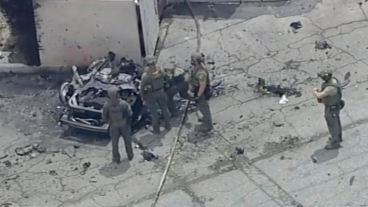 Law enforcement investigate a vehicle after an explosion on Saturday, May 17, 2025 in Palm Springs, Calif. (ABC7 Los Angeles via AP)