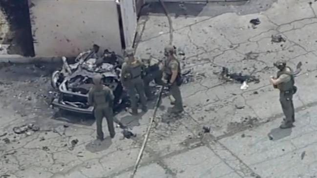 Law enforcement investigate a vehicle after an explosion on Saturday, May 17, 2025 in Palm Springs, Calif. (ABC7 Los Angeles via AP)