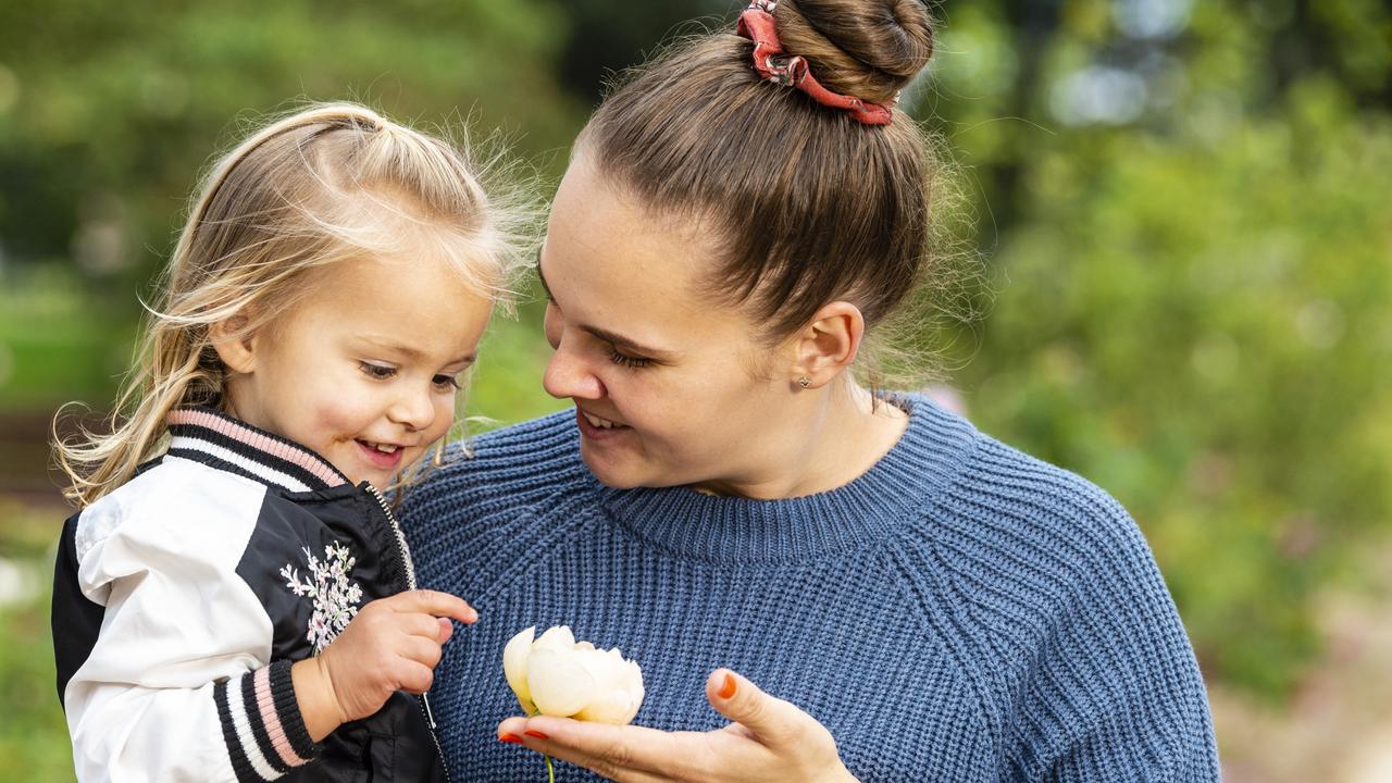 Eleisha Park is shown a rose by daughter Raegan on Mother's Day during celebrations in the Queensland State Rose Garden, Newtown Park, Sunday, May 8, 2022. Picture: Kevin Farmer