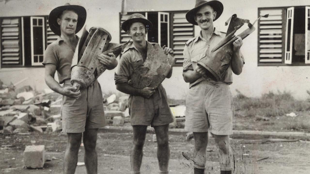 Pte F. Conlin of Sydney, Driver J. Hankin of Sydney, and Sergeant Babb of Balgownie are holding parts of Japanese bombs dropped during the raid on Darwin. WWII - World War II - Australia - Air raids - 1942-1943.