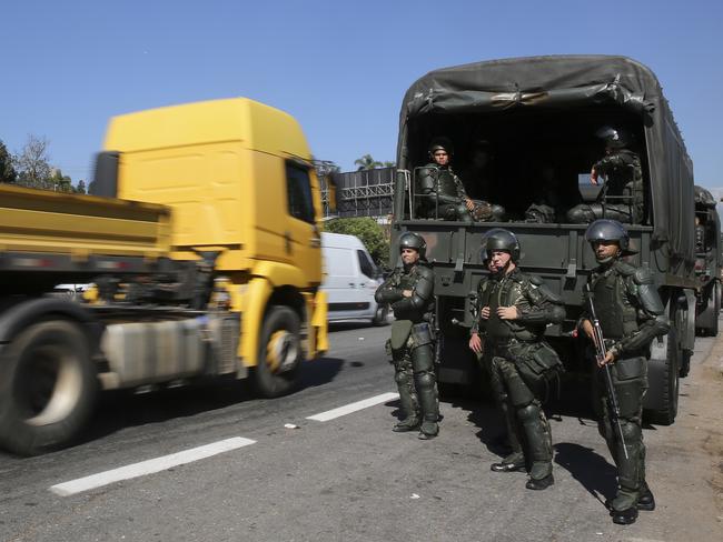 Soldiers stand guard along federal highway after the military cleared truckers who were protesting rising fuel costs. Picture: Andre Penner)