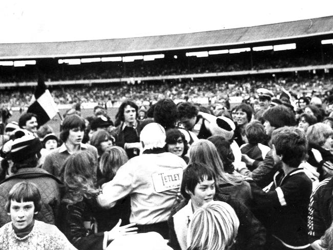 Richmond's Michael Roach is swamped by the crowd.