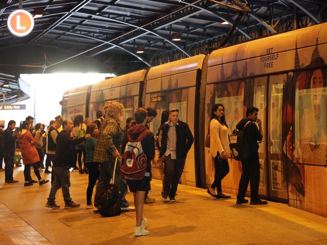 Passengers board the Sydney light rail at Central Station during industrial action by bus drivers. Picture: Christian Gilles