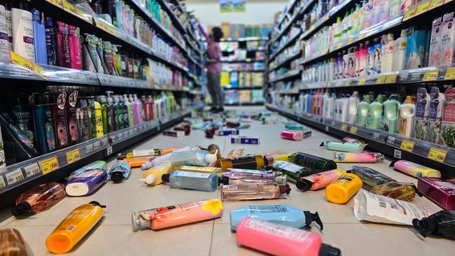 Bottles strewn on the floor of a supermarket in Yilan. Picture: AFP