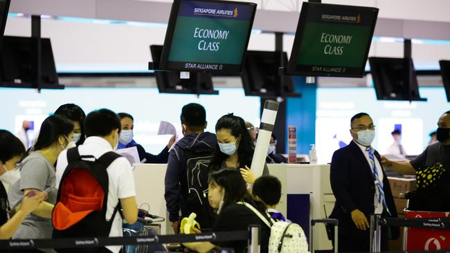 People checking in while wearing face masks for an international flight to China during Australia’s closed border period. Picture: NCA NewsWire / Gaye Gerard