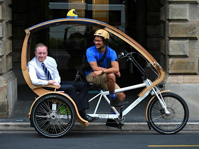 Adelaide Lord Mayor Martin Haese getting into an eco caddy (green taxi) for a ride around the city. Picture: Roy VanDerVegt