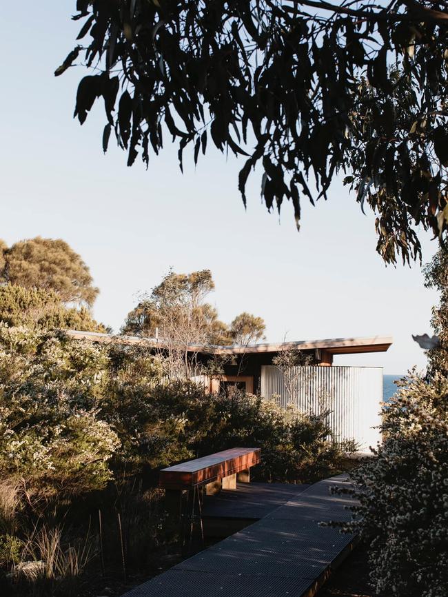 Little Beach Co’s Bath House, which has been designed to mimic conjoined steel water tanks and has a raised butterfly roof over its central shared basins.