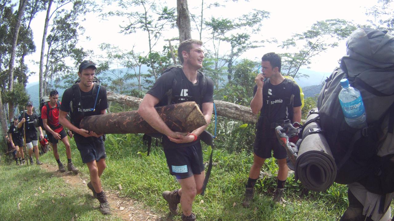 Xavier Ellis legs a log up a hill during the Kokoda trek.