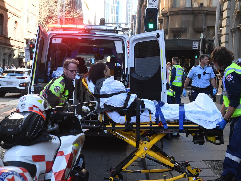 A woman is taken by ambulance from Hotel CBD. Picture: Dean Lewins/AAP