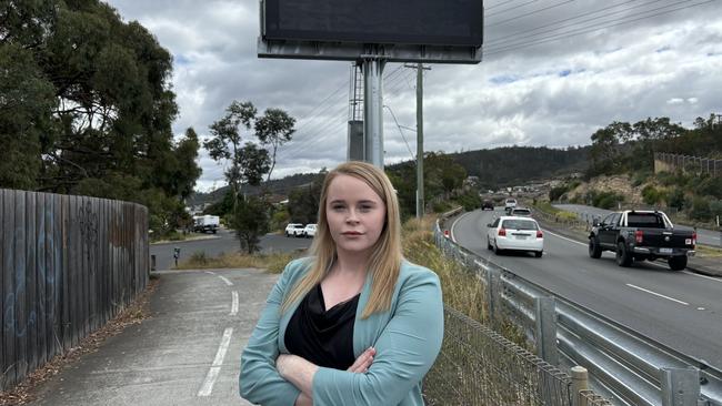 Labor transport spokeswoman Meg Brown in front of a blank electronic traffic sign on the South Arm Highway. Picture: Simon McGuire.