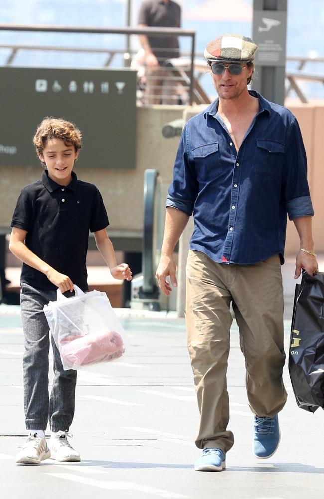 Matthew McConaughey pictured at Sydney Opera House with his son taking in the sights and buying some boots from the Ugh shop at Circular Quay. Matt enjoyed a quiet lunch at Bennelong. Picture: Matrix