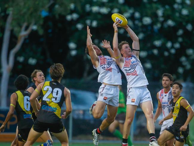 Jesse Clark (ball) the first game under lights at Nightcliff Oval.Picture GLENN CAMPBELL