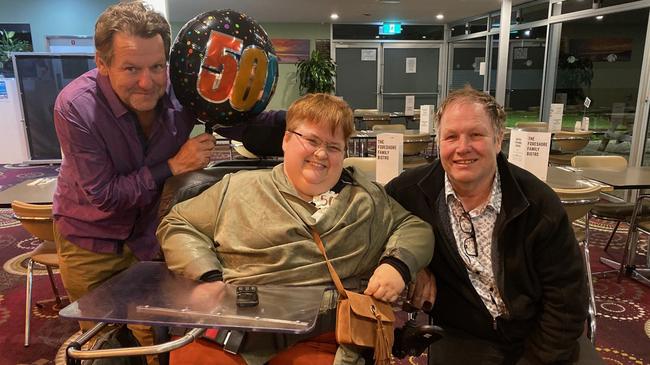 Fiona Searle with brothers Reg Searle and Gus Searle on her 50th birthday. Fiona died on May 8 after a fall outside a polling booth on election day. Picture: Supplied